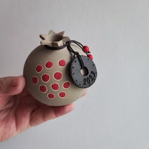 Ceramic pomegranate ornament with 2023 charm, light grey pomegranate with red seeds, lucky pomegranate for 2023
