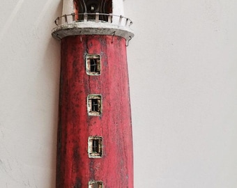 May include: A red and white lighthouse sculpture made of wood. The lighthouse has four windows and a white roof.