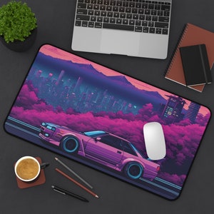 May include: A pink car with a city skyline and purple trees in the background. The car is driving on a road with a white line down the center. The mousepad is black with a smooth surface.