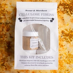 May include: A white package labeled "Scour & Mordant CELLULOSE FIBERS" with a clear window showing a jar of "OAK GALL TANNIN". The kit includes aluminum sulphate, oak gall, and detailed directions for botanical dyeing of cellulose fibers.