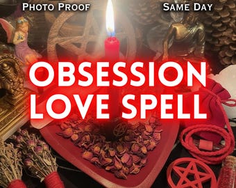 May include: A red candle burning in a heart-shaped dish filled with dried rose petals, featuring the text "PHOTO PROOF", "SAME DAY", "OBSESSION LOVE SPELL", and "SACREDSPELLS". The scene includes a wooden pentacle, a small fairy figurine, a gold statue, and red cord.