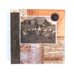 May include: A square mixed-media collage featuring a sepia-toned photograph of a person with chickens in a farmyard. The background includes vintage calendar text, cursive handwriting, a dark circular button, and the printed code AG 841309.