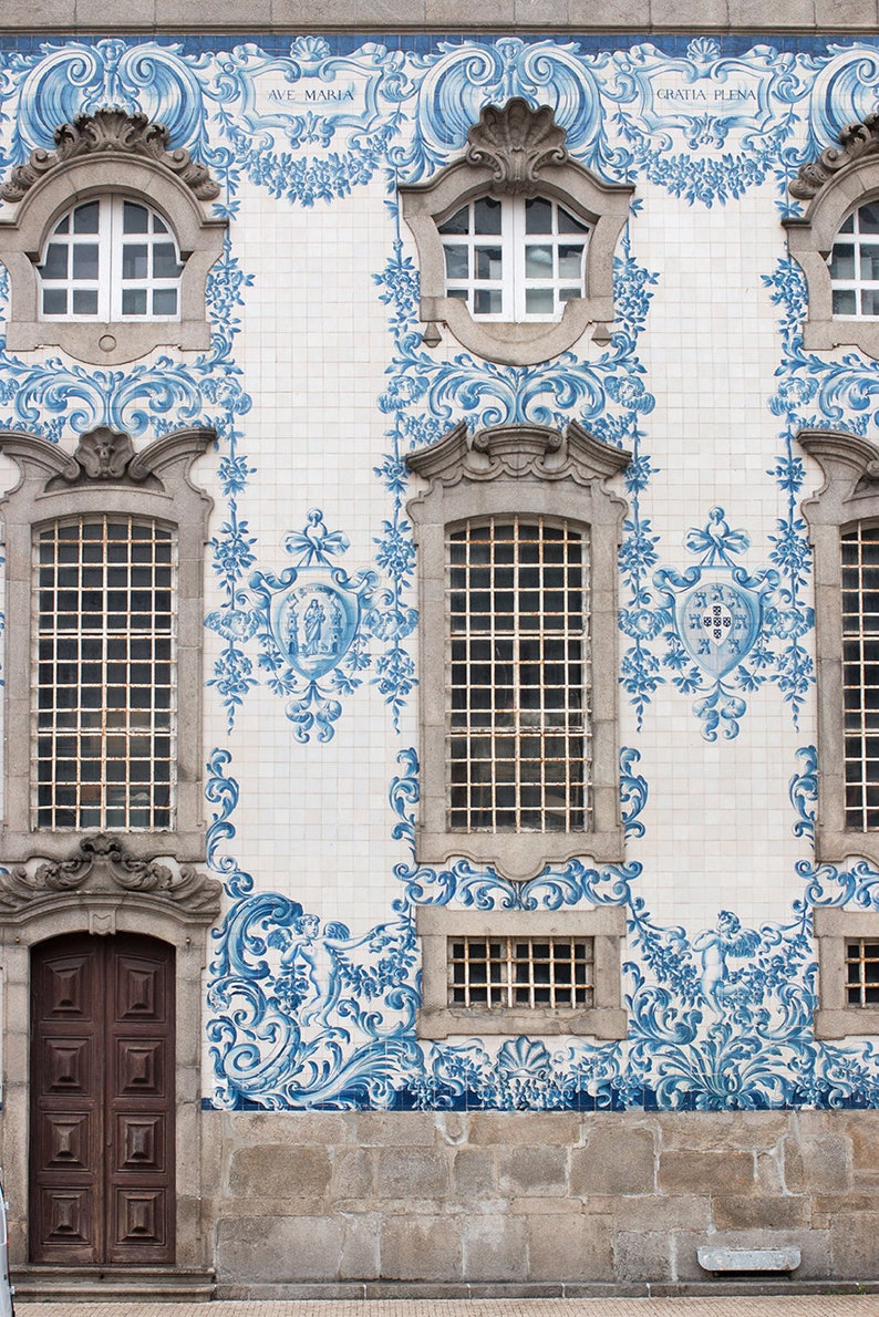 May include: Exterior of a building with ornate blue and white tilework. The facade features arched windows, a wooden door, and decorative floral patterns. The words "AVE MARIA" and "GRATIA PLENA" are visible.