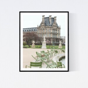 May include: A view of a large building with a statue in front of it. Green chairs are arranged in a semi-circle around a fountain.