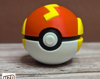 May include: A red and white Poke Ball with a yellow lightning bolt design. The Poke Ball is a popular collectible toy.