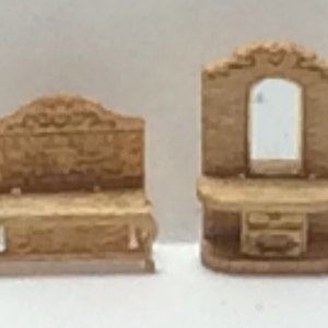 May include: Two miniature wooden furniture pieces, a vanity with a mirror and a bench. Both pieces are detailed with carvings and have a light brown finish.