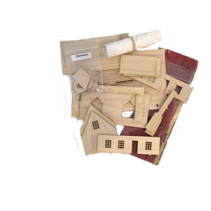 Peut inclure: Un ensemble de pi&egrave;ces en bois pour la construction d'une maison miniature, comprenant des murs, des &eacute;l&eacute;ments de toit et des fen&ecirc;tres. Les pi&egrave;ces sont dans un sac &eacute;tiquet&eacute; "Dormers".