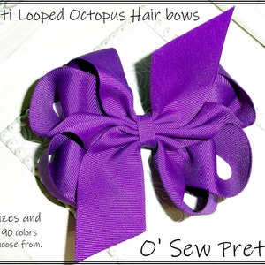 May include: Purple multi-looped octopus hair bow.  The bow is made of a thick, textured ribbon.  "O' Sew Pretty" is written in white text at the bottom of the image.