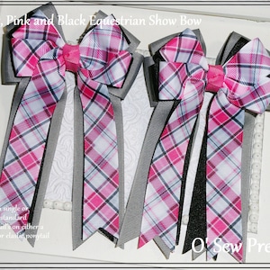 May include: Three equestrian show bows with grey, pink, and black plaid ribbon. The bows are tied with a single loop and have long tails. The text "O Sew Pretty" is visible in the bottom right corner of the image.