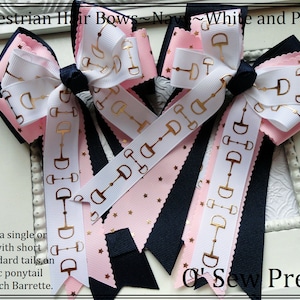 May include: Three navy, pink, and white equestrian hair bows with gold stirrup prints. The bows are tied with a gold ribbon and have a gold star pattern on the pink ribbon. The text "O' Sew Pretty" is visible in the bottom right corner of the image.