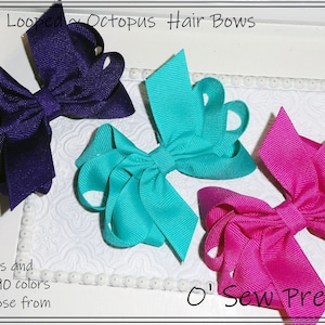 May include: Three colorful octopus hair bows in purple, teal, and hot pink. The bows are made of grosgrain ribbon and have multiple loops. The image includes the text "Multi Looped Octopus Hair Bows", "2 Sizes and Over 90 colors to choose from", and "O' Sew Pretty".