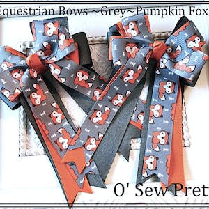 May include: Equestrian bows in grey, pumpkin, and black. The bows feature a repeating pattern of orange foxes on a grey background. The text "Equestrian Bows ~ Grey ~ Pumpkin Fox" and "O' Sew Pretty" are visible.