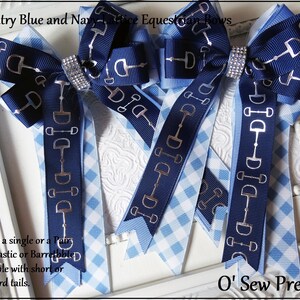 May include: Blue and white gingham ribbon equestrian bows with silver stirrup accents. Sold as a single or a pair with elastic or barrette. Available with short or standard tails. O' Sew Pretty.