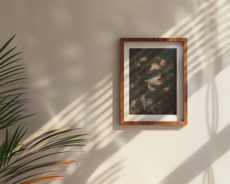 May include: A framed art print depicting a person with a blindfold and a floral crown. The portrait is set against a dark backdrop, with the person wearing a black lace top. The frame is made of wood.