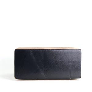 May include: A black cardboard box with a textured surface.