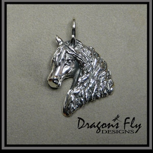 May include: Silver pendant charm featuring a detailed sculpted horse head with a flowing mane. The pendant is a three-dimensional design and is suitable for jewelry making.