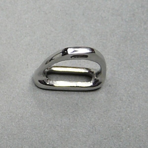 May include: A silver metal ring with a rounded, oval-shaped opening. The ring is smooth and shiny.