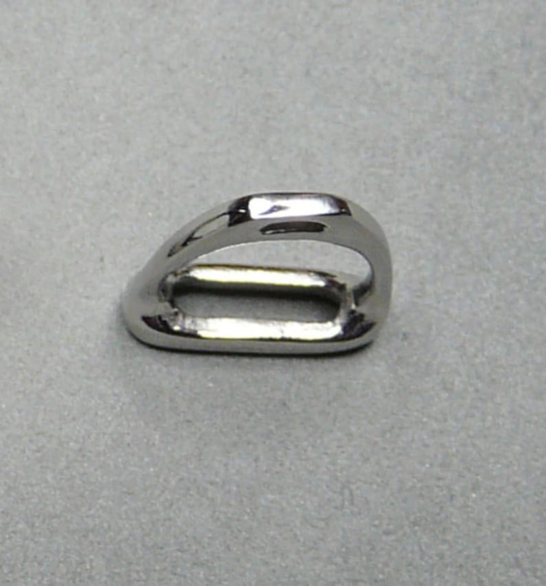 May include: A silver metal ring with a rounded, oval-shaped opening. The ring is smooth and shiny.