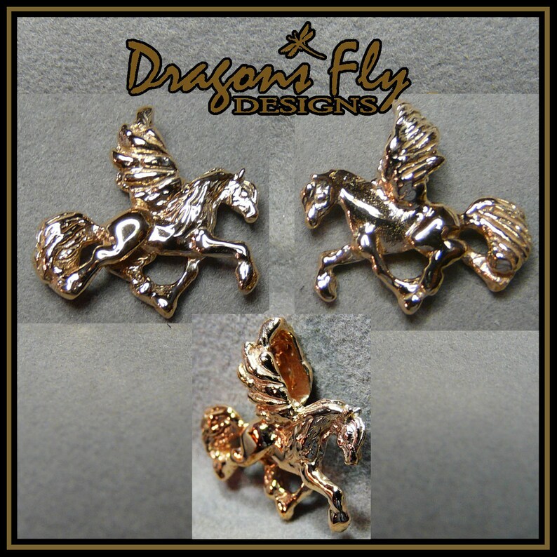 May include: Three gold-coloured winged horse charms, each with a different pose. The charms are on a grey background with the text "Dragons Fly Designs" above them.