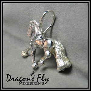 May include: A silver horse charm pendant with a detailed mane and tail. The charm has a loop for attaching to a necklace or bracelet.