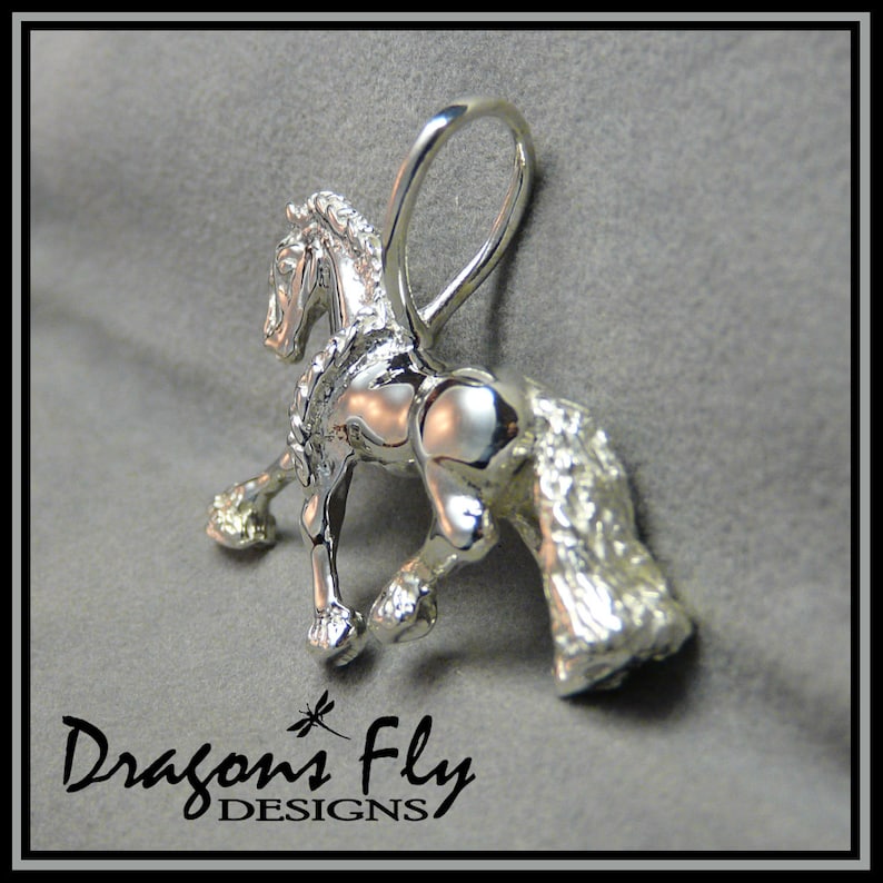 May include: A silver horse charm pendant with a detailed mane and tail. The charm has a loop for attaching to a necklace or bracelet.