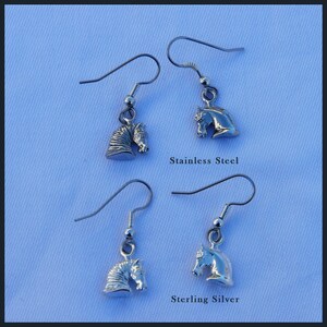 May include: Two pairs of silver horse head earrings. The top pair is labeled "Stainless Steel" and the bottom pair is labeled "Sterling Silver".