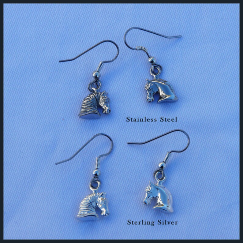 May include: Two pairs of silver horse head earrings. The top pair is labeled "Stainless Steel" and the bottom pair is labeled "Sterling Silver".