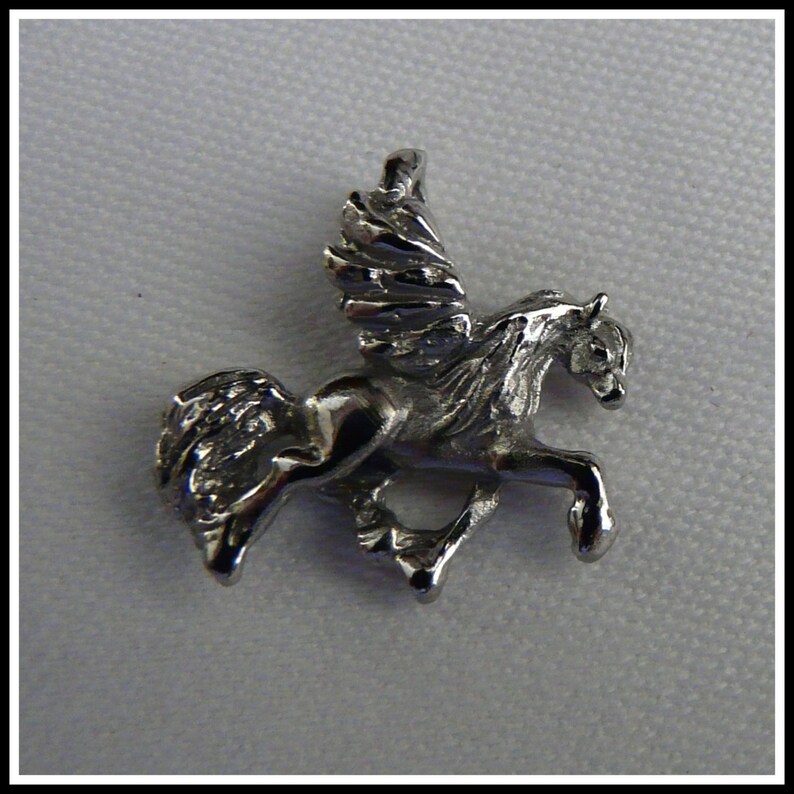 May include: Silver-toned pendant charm featuring a detailed sculpted winged horse, or pegasus, in flight.