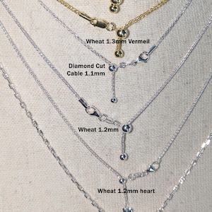 K&ouml;nnte beinhalten: Eine Sammlung zarter Halsketten mit verschiedenen Kettenstilen, darunter Diamantschliff, Weizen und Anker. Die Halsketten sind in Gold-Vermeil und Silber erh&auml;ltlich, mit verstellbaren L&auml;ngen. Text auf dem Bild enth&auml;lt Kettenart und -gr&ouml;&szlig;e.