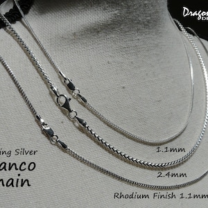 May include: Three sterling silver Franco chains in different widths. The chains are 1.1 mm, 2.4 mm, and 1.1 mm with a rhodium finish. Dragonfly Designs.