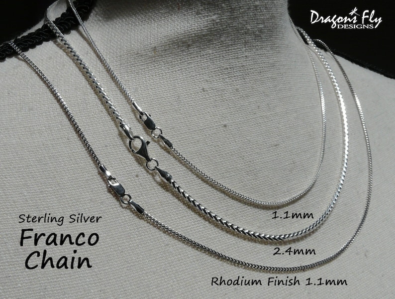 May include: Three sterling silver Franco chains in different widths. The chains are 1.1 mm, 2.4 mm, and 1.1 mm with a rhodium finish. Dragonfly Designs.