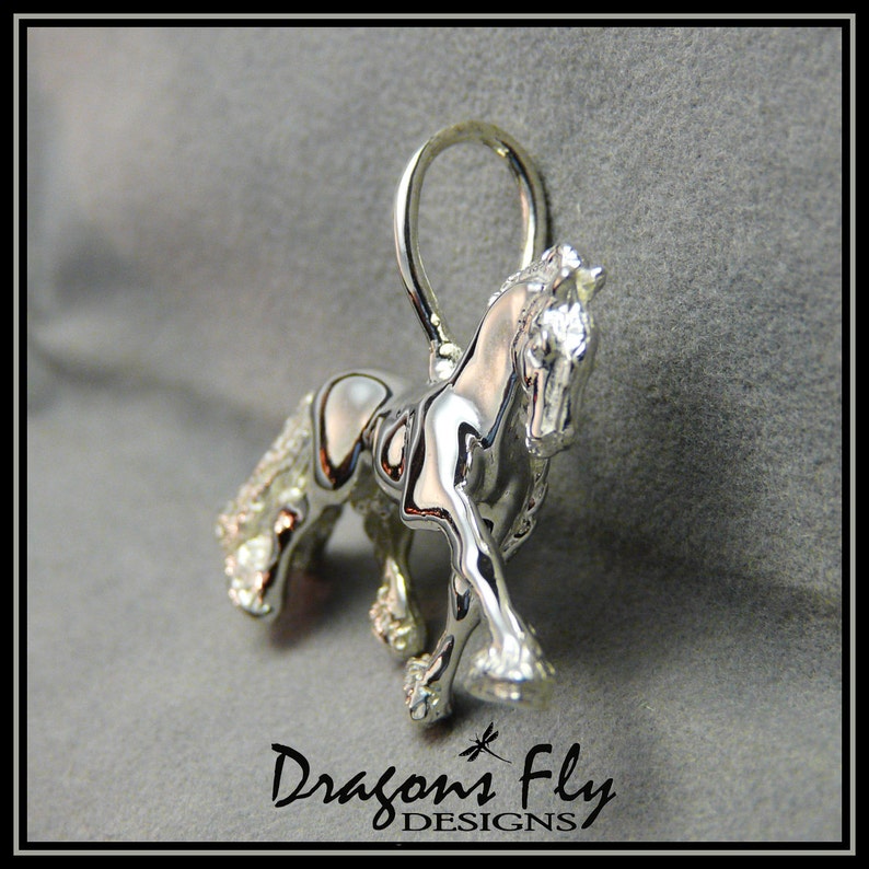 May include: Silver horse charm pendant with a detailed design and clear crystals. The charm is attached to a silver loop.