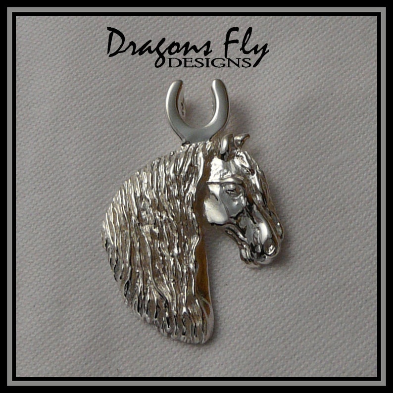 May include: Silver horse head pendant with a horseshoe charm. The pendant is detailed with a textured mane and a realistic horse head.
