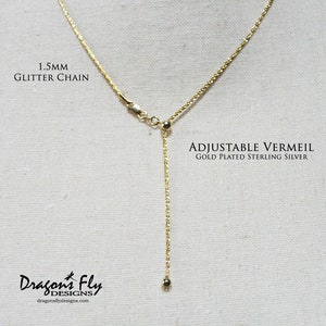 May include: An adjustable chain necklace made from gold-plated sterling silver, featuring a 1.5mm glitter chain. The chain is adjustable with a sliding bead and a lobster clasp.