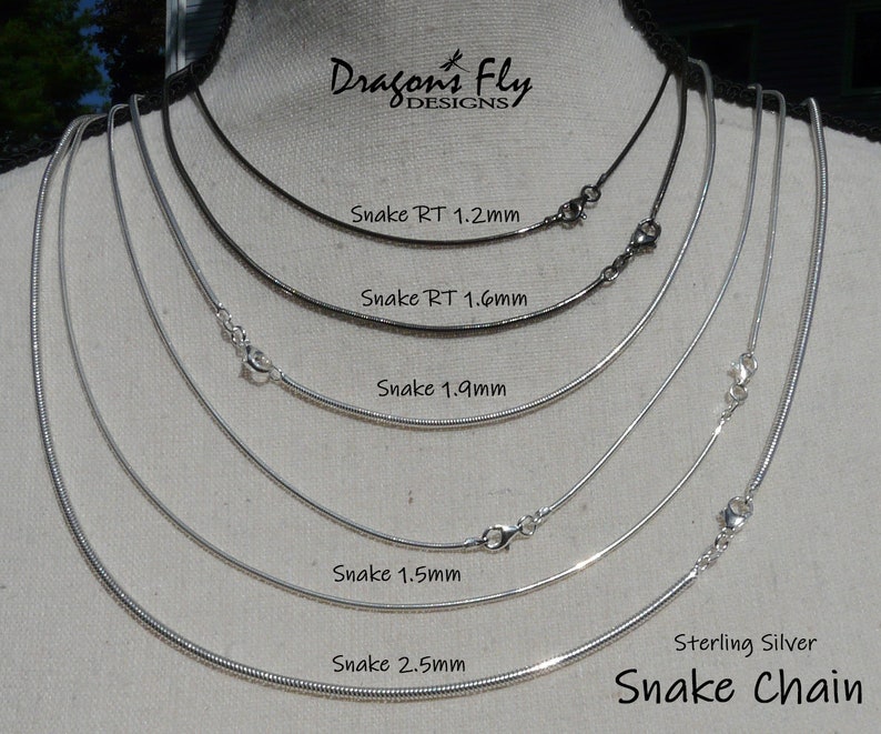 May include: A close-up of six silver snake chains of different thicknesses, displayed on a mannequin. The chains are labelled with their respective sizes in millimetres: 1.2mm, 1.6mm, 1.9mm, 1.5mm, and 2.5mm. The text "Sterling Silver Snake Chain" is also visible at the bottom of the image.
