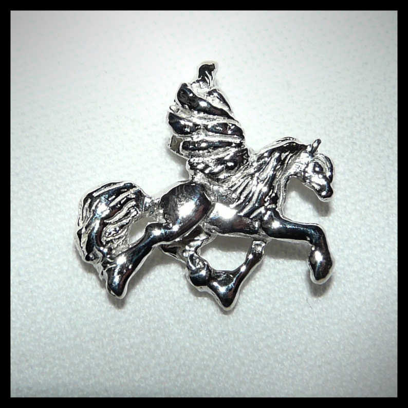 May include: A silver-toned winged horse figurine, also known as a Pegasus, is depicted in mid-flight with its wings spread out. The figurine is detailed with a flowing mane and tail.