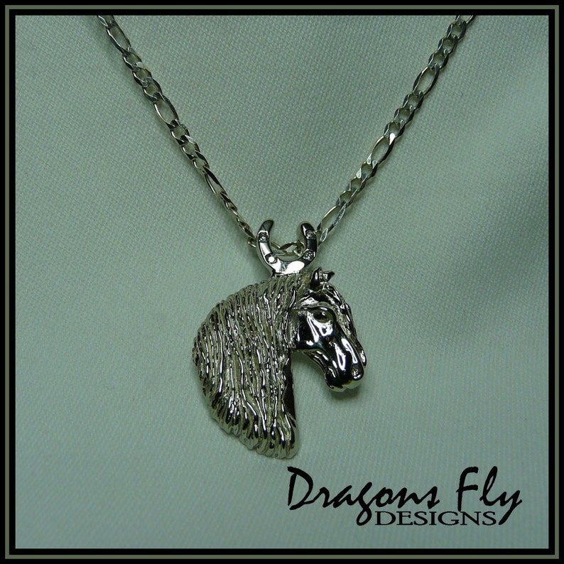 May include: Silver horse head pendant necklace with a horseshoe charm. The necklace is on a silver chain.