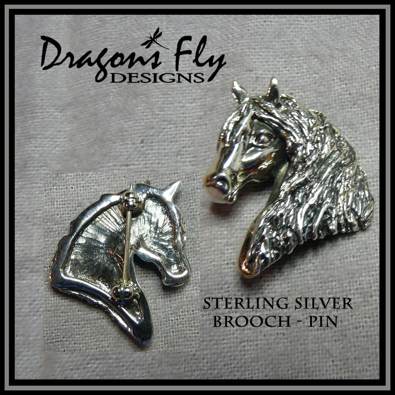 May include: Sterling silver horse head brooch pin. The pin is shown from both the front and back. The back shows the pin mechanism.