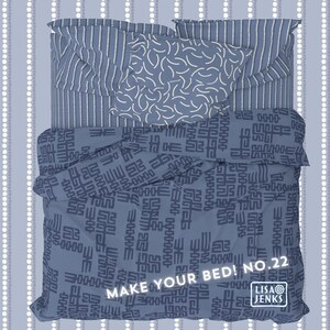 May include: A blue and white patterned bedding set with a geometric design. The duvet cover features a repeating pattern of abstract shapes in dark blue on a light blue background. The pillowcases have a striped pattern in white and light blue. The text "MAKE YOUR BED! NO. 22" is printed on the duvet cover. The text "LISA JENKS" is printed on the pillowcase.