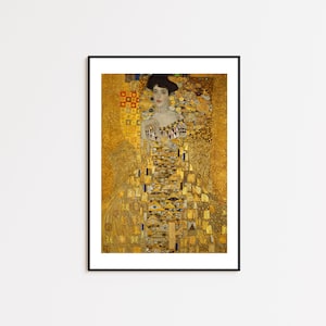 Puede incluir: Impresión enmarcada del "Retrato de Adele Bloch-Bauer I" de Gustav Klimt. La obra de arte presenta a una mujer con un vestido dorado con patrones intrincados y un fondo dorado. La impresión está en un marco negro, lista para colgar.