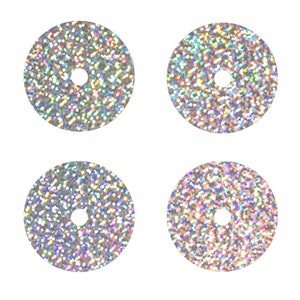 May include: Four iridescent silver glitter round stickers with a small hole in the center.