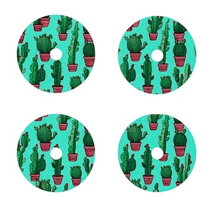 May include: Four round stickers with a turquoise background and a white circle in the center. The stickers are covered in a repeating pattern of green cacti in red pots.