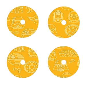 May include: Four yellow round stickers with white outlines of Star Wars characters. The stickers feature Darth Vader, R2-D2, Yoda, and the Death Star.