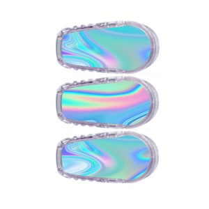 May include: Three iridescent blue and pink patterned stickers for a medical device.