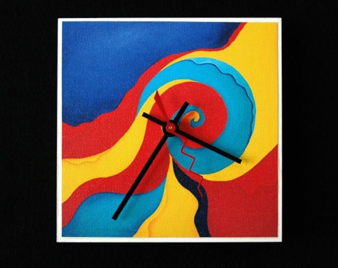 Abstract art clock with vivid reds, blues and yellows.