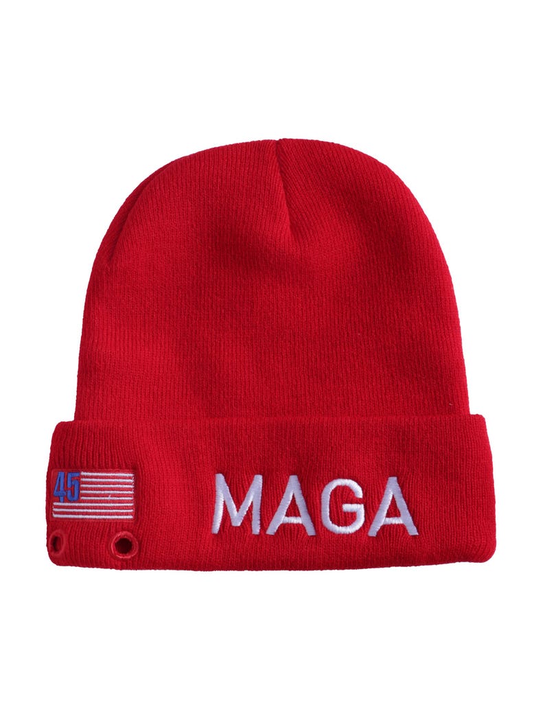 May include: Red knit beanie with a white American flag and the text "MAGA" embroidered on the front.