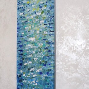 May include: Abstract painting on canvas with a blue, green, and white color scheme. The painting has a textured surface and appears to depict water.