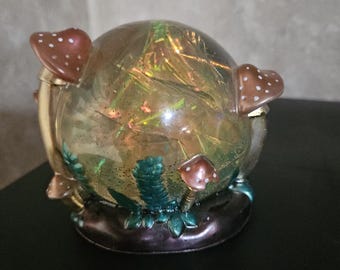Iridescent resin crystal ball with colored mushrooms