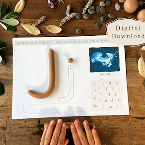 May include: A learning activity sheet with the letter "J" formed with brown clay. The sheet includes a jellyfish illustration and letter matching. The words "Digital Download" are in the upper right corner.