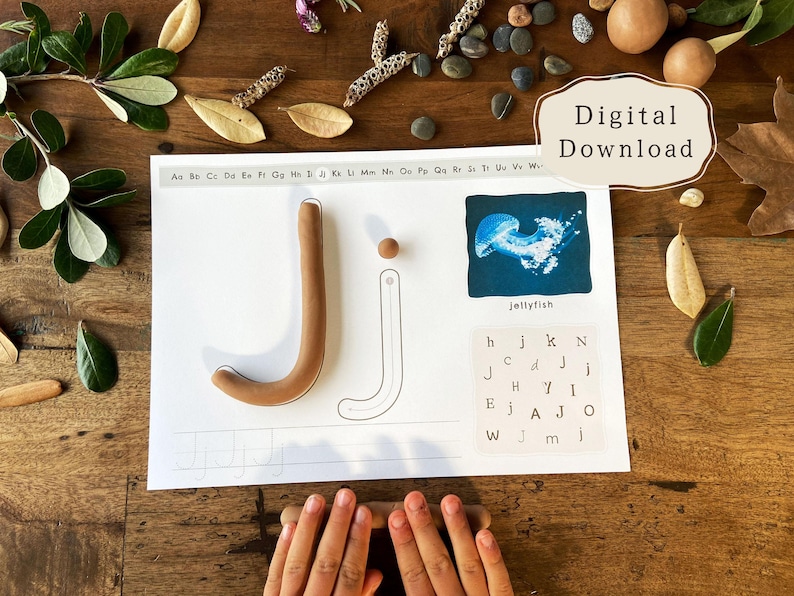 May include: A learning activity sheet with the letter "J" formed with brown clay. The sheet includes a jellyfish illustration and letter matching. The words "Digital Download" are in the upper right corner.